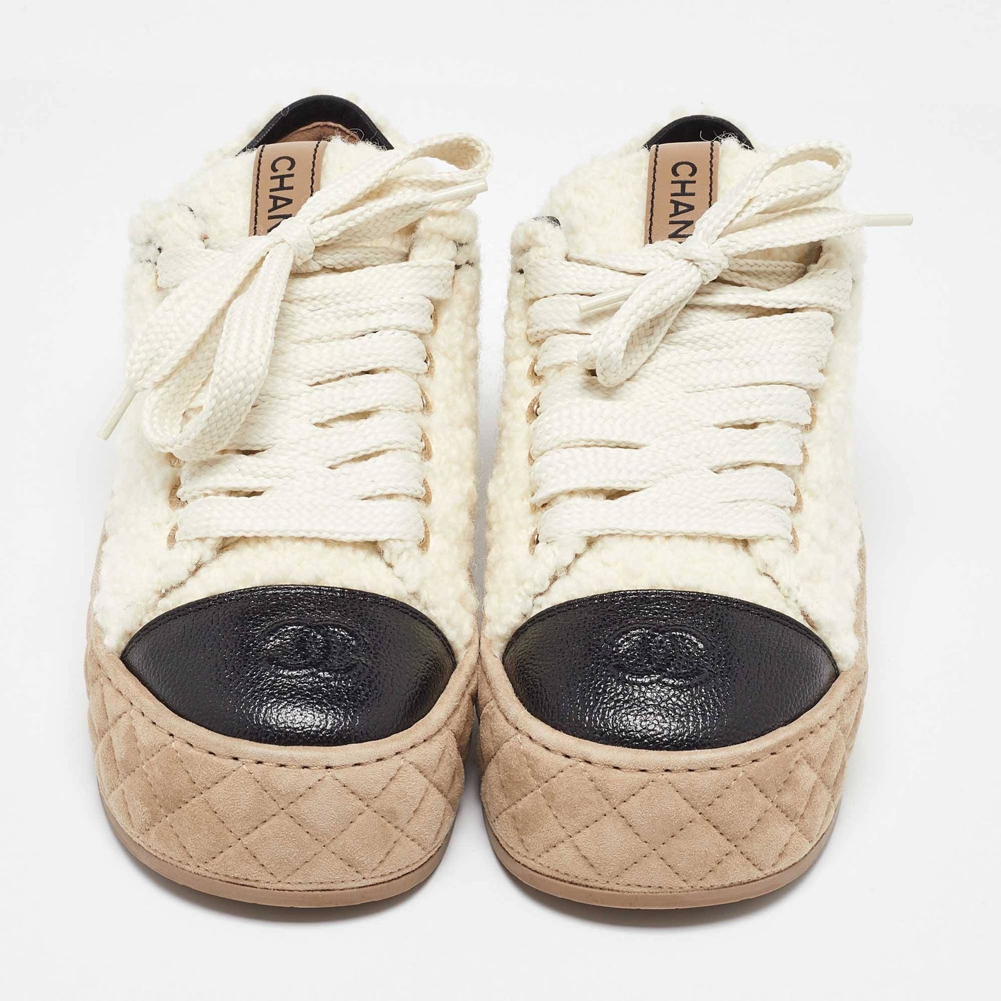 CHANEL
Chanel Beige/Black Shearling and Leather Cap Toe CC Low Top Sneakers Size 36.5